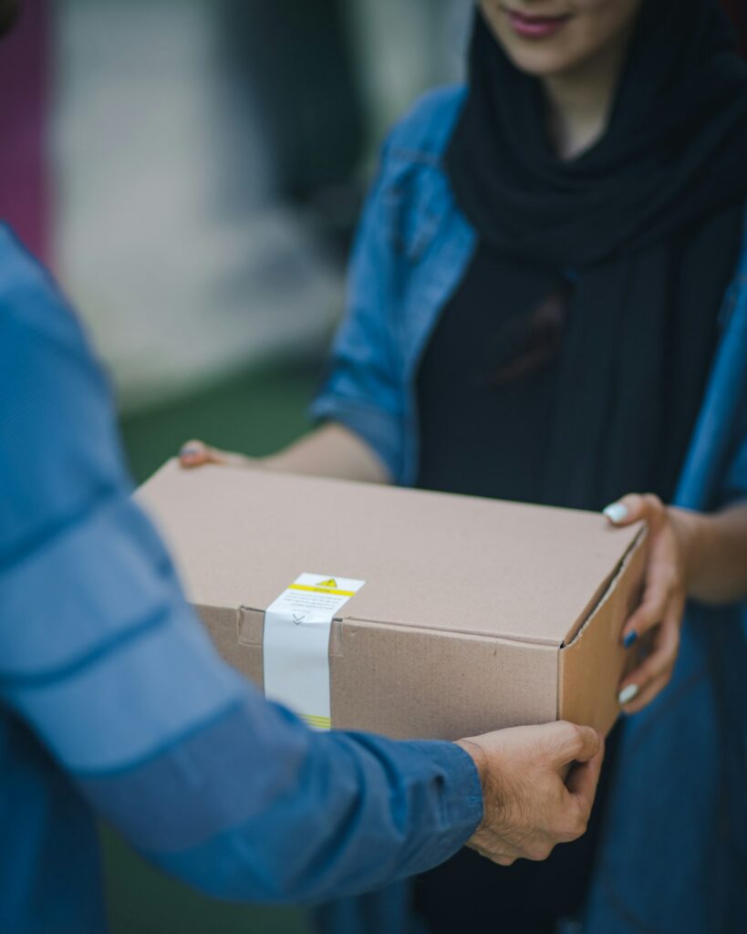 Courier handing over a Peasley Store delivery box